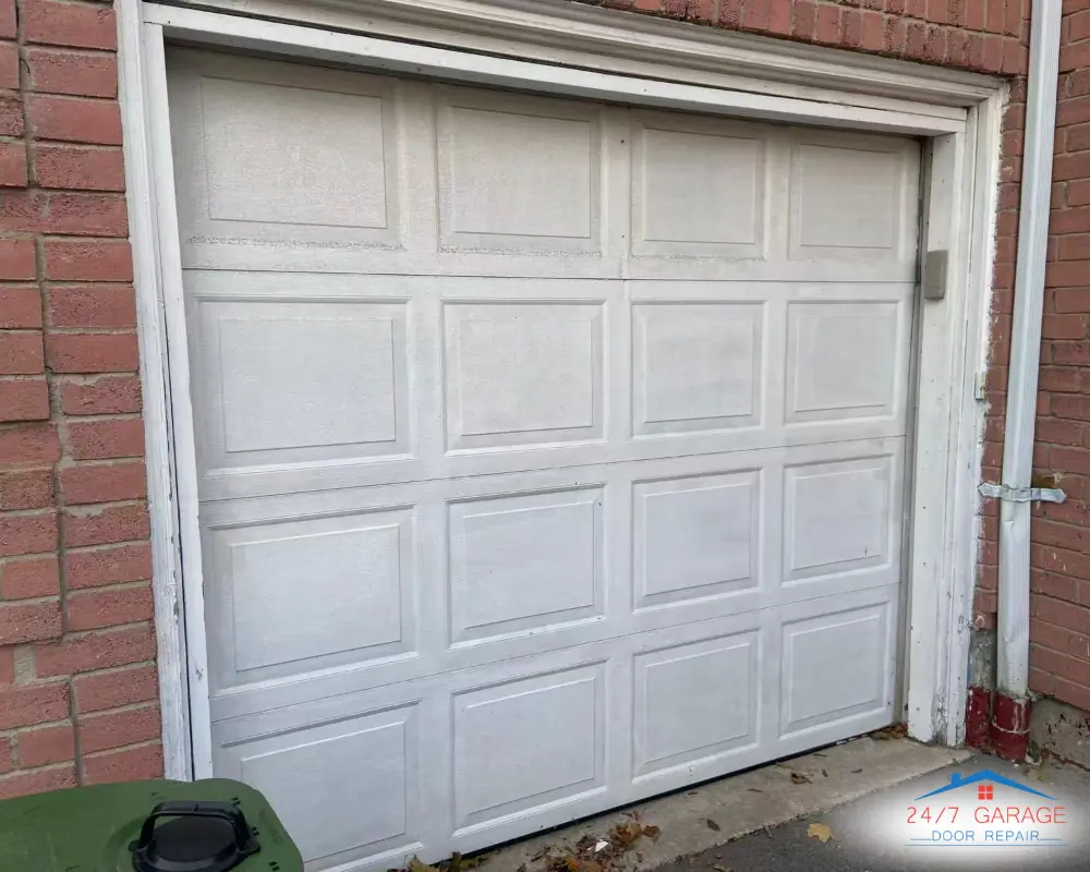Older garage door on red brick bungalow common in Scarborough neighborhoods